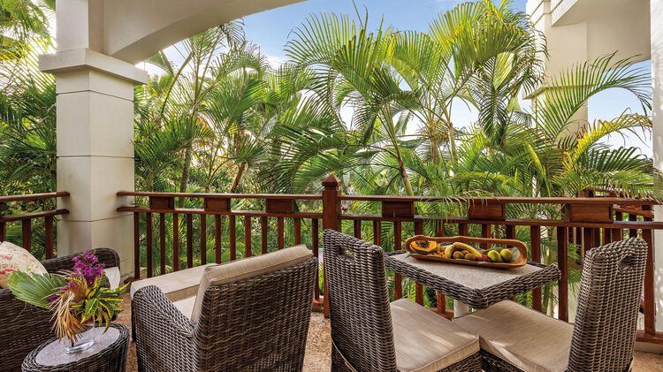 Table and chairs on balcony facing garden