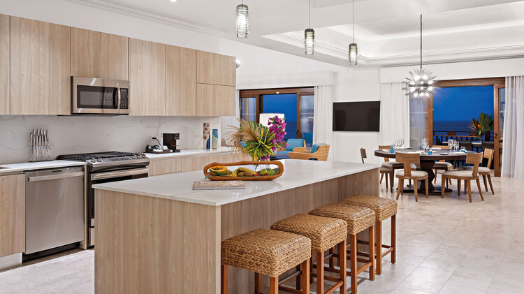 Kitchen island, oven, dining room table and view of balcony