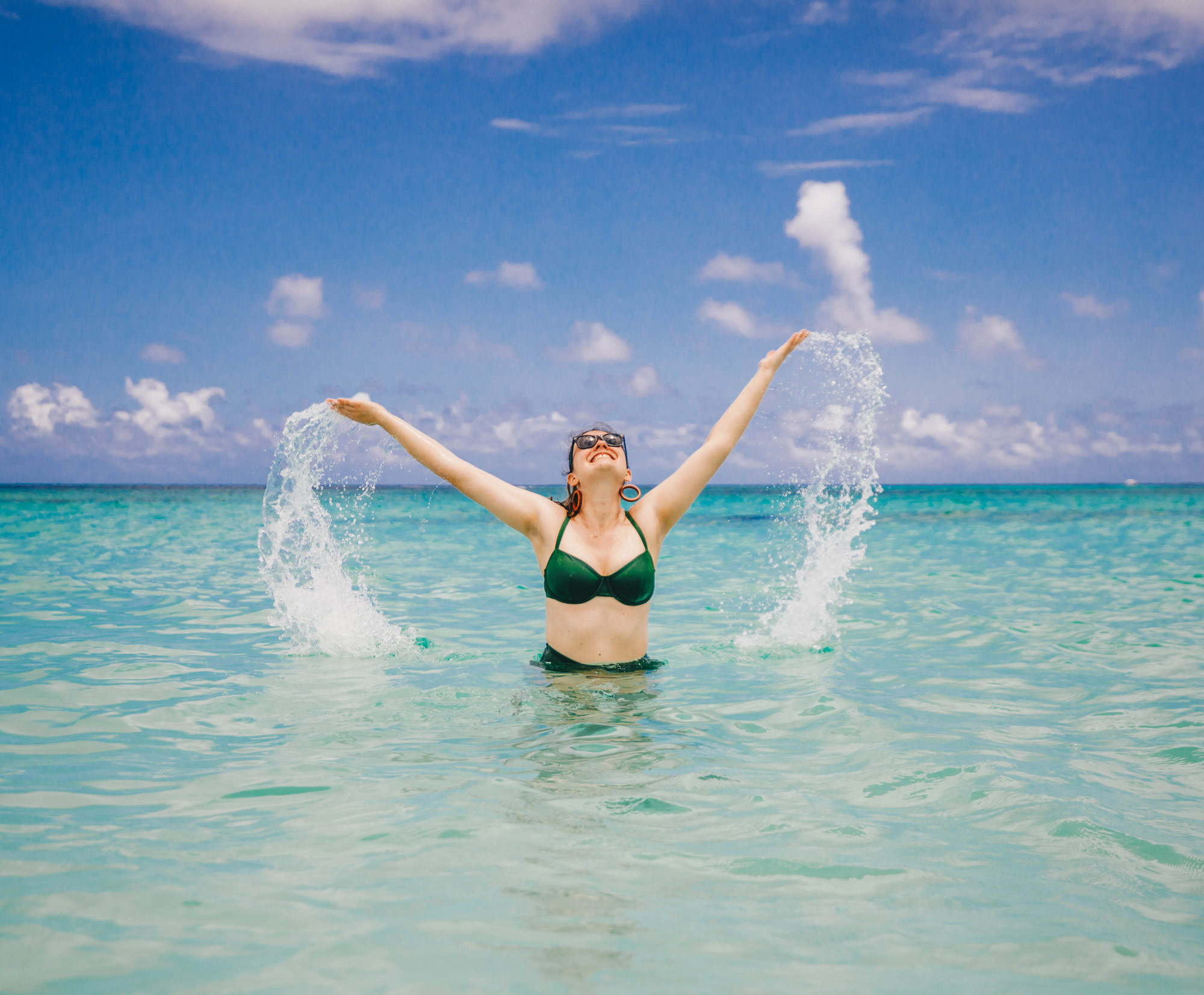 Woman splashing in Caribbean water