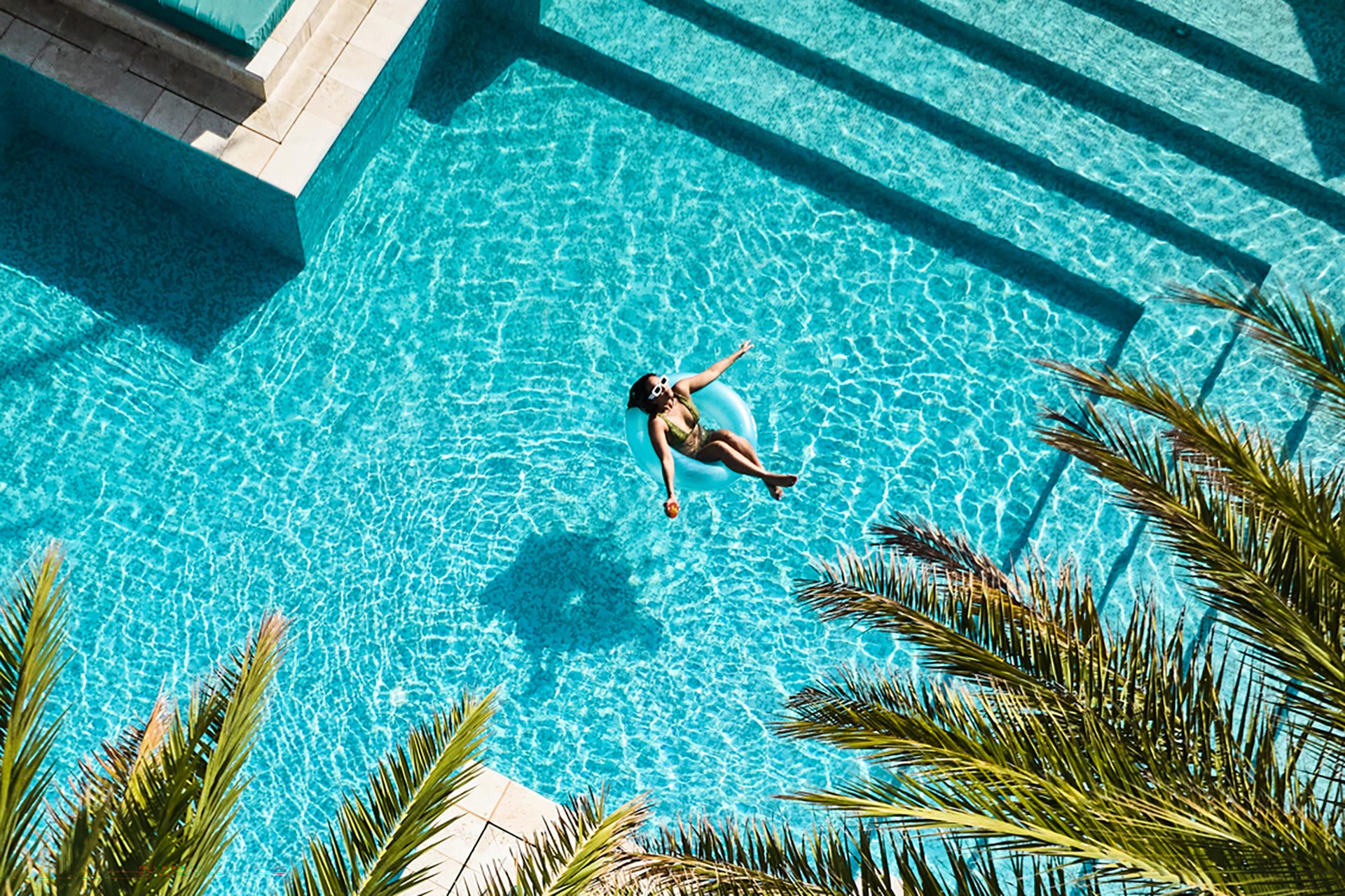 A woman relaxing in an outdoor pool