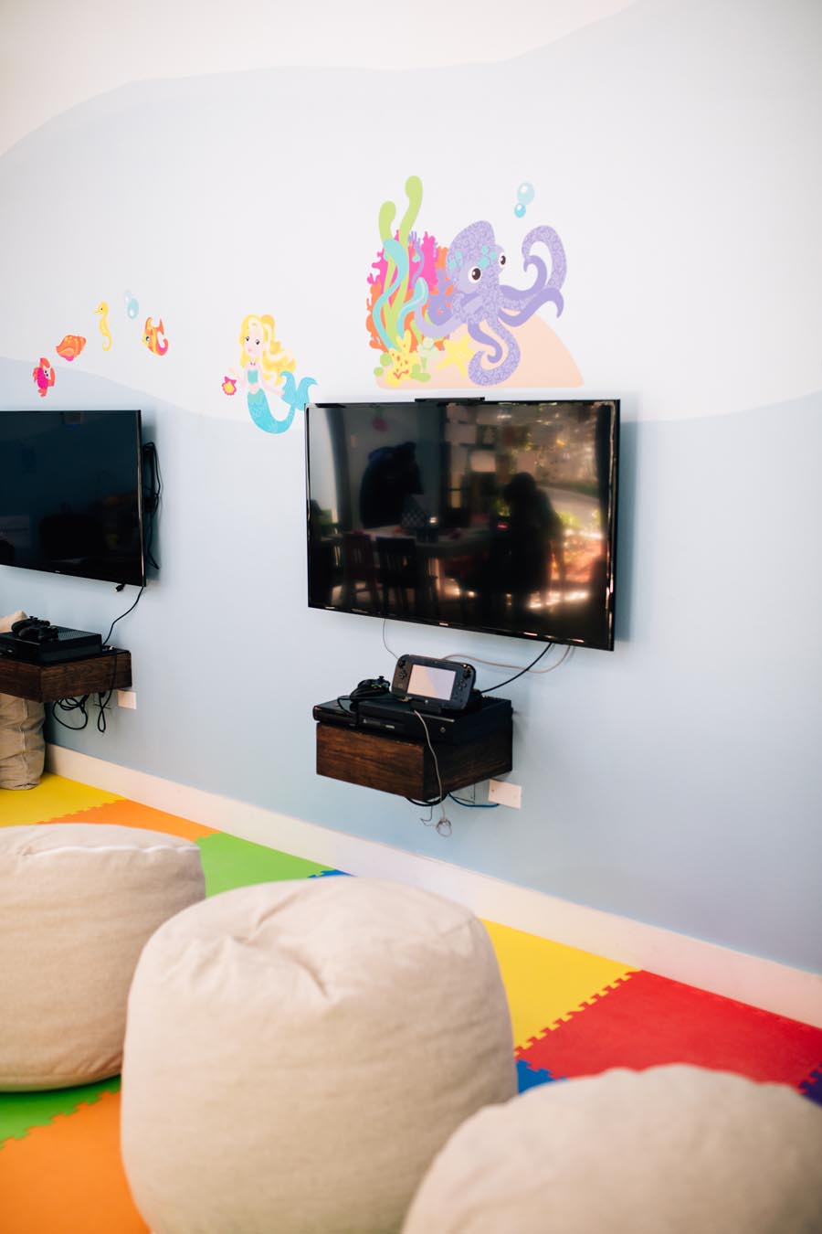 TV and bean bag chair with colourful mat